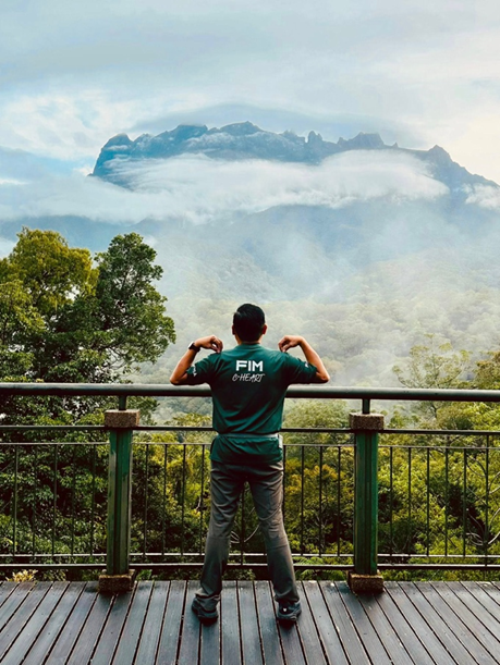 Facing the majestic Mount Kinabalu in the iconic FIM C-Heart shirt Image