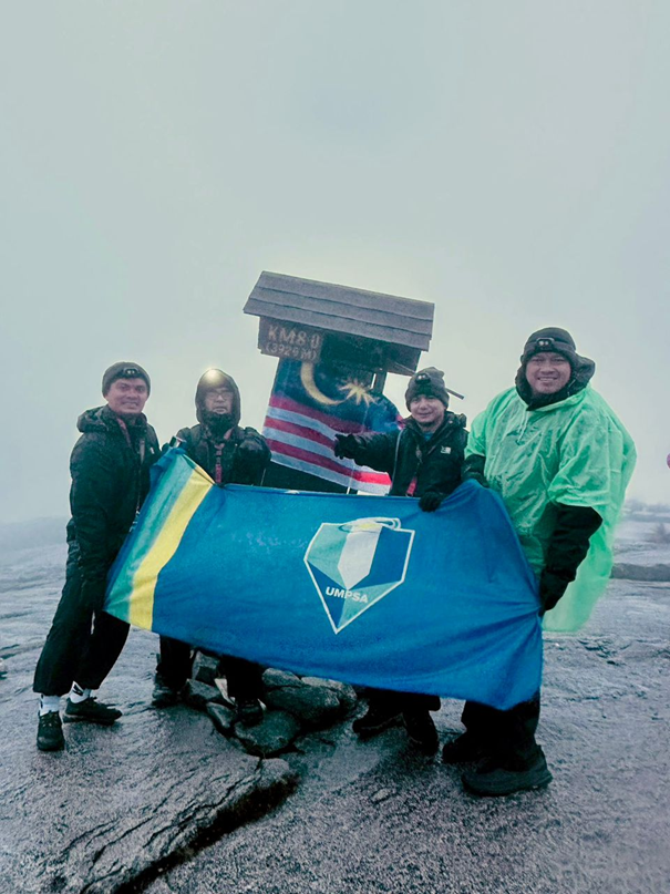 Mission accomplished: The UMPSA flag proudly flown at the summit of Mount Kinabalu. Image